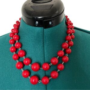 Red double-strand beaded statement necklace.